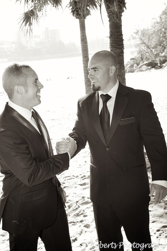 Groom shaking hand with groomsman - wedding photography sydney